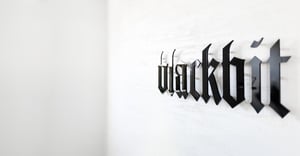 Blackbit lettering on house wall